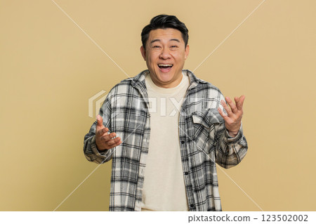 Amused smiling cheerful Asian man laughing out loud funny ridiculous joke anecdote bullying abuse Amused smiling cheerful Asian man laughing out loud funny ridiculous joke anecdote bullying abuse 123502002