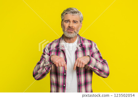 Mature man urging donations, heartfelt plea, pointing down gesture support call, genuine gratitude Mature man urging donations, heartfelt plea, pointing down gesture support call, genuine gratitude 123502054