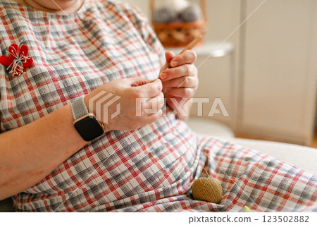 Close-up view of hands of an older woman crocheting 123502882