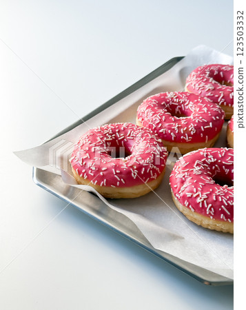 Pink donuts on metal tray and white table Pink donuts on metal tray and white table 123503332