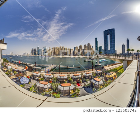 Dubai Marina featuring high rise buildings, a yacht harbor, and a lively promenade Dubai Marina featuring high rise buildings, a yacht harbor, and a lively promenade 123503742