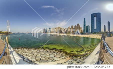 Dubai Marina featuring high rise buildings, a yacht harbor, and a lively promenade Dubai Marina featuring high rise buildings, a yacht harbor, and a lively promenade 123503743