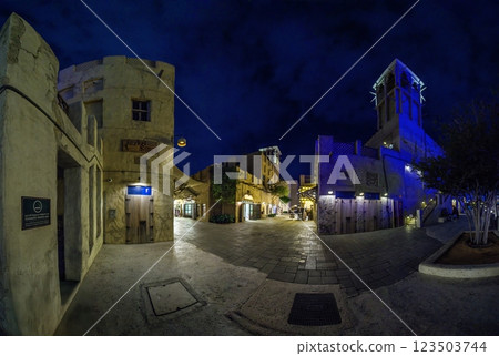 Historic souk at Dubai Creek at night with illuminated buildings and water reflections Historic souk at Dubai Creek at night with illuminated buildings and water reflections 123503744