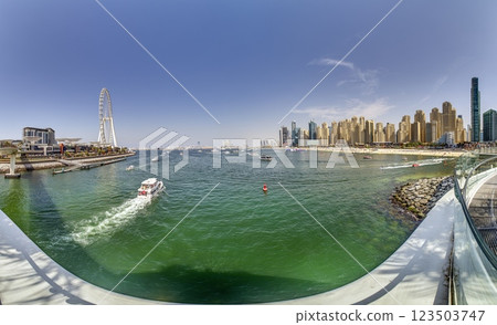 Dubai Marina featuring high rise buildings, a yacht harbor, and a lively promenade Dubai Marina featuring high rise buildings, a yacht harbor, and a lively promenade 123503747