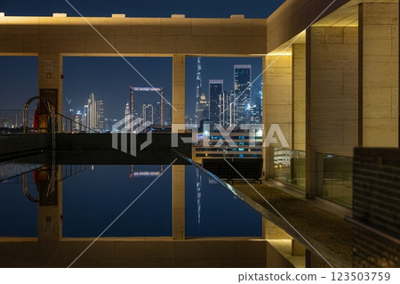 The illuminated Dubai skyline reflecting in a rooftop pool at night The illuminated Dubai skyline reflecting in a rooftop pool at night 123503759