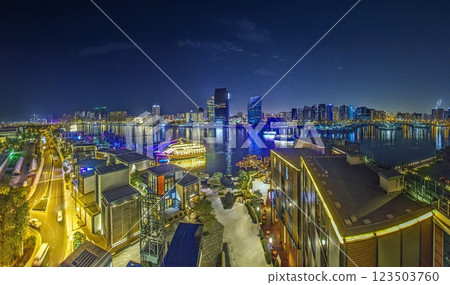Dubai Creek at night with a stunning skyline, illuminated buildings, and shimmering reflections 123503760