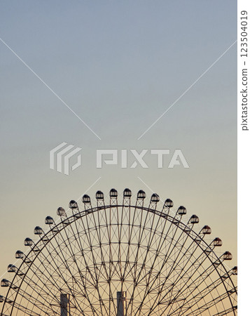 large ferris wheel against pastel sky, showcasing its intricate structure and design. image captures sense of wonder and excitement, perfect for amusement park themes 123504019