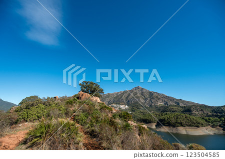Majestic mountain landscape with clear blue sky and lush greenery, La Concepcion reservoir in 123504585