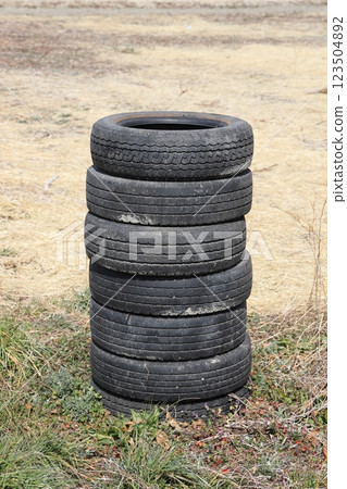 Illegal dumping of waste tires 123504892