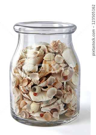 glass decorative jar with different shells and pebbles isolated on white background glass decorative jar with different shells and pebbles isolated on white background 123505162