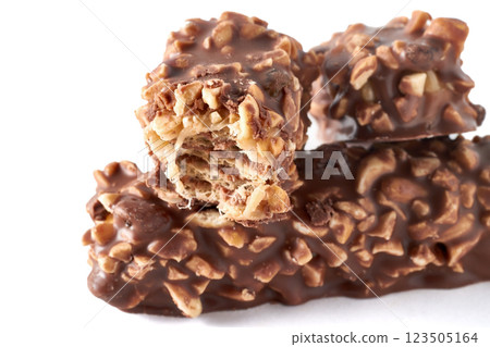 three broken sweet wafer caramel bars covered with nuts and chocolate isolated on white background three broken sweet wafer caramel bars covered with nuts and chocolate isolated on white background 123505164