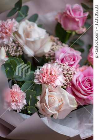 Delicate composition of white and pink roses in a basket 123505233