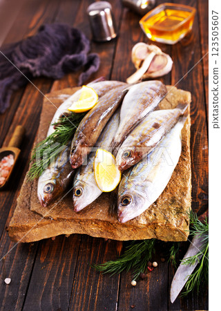 Fresh small fish on stone board 123505607