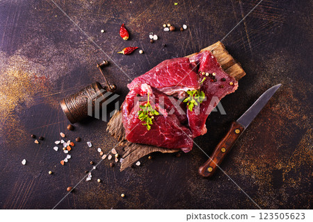 Raw marbled beef steaks on a dark slate, stone or concrete background . 123505623