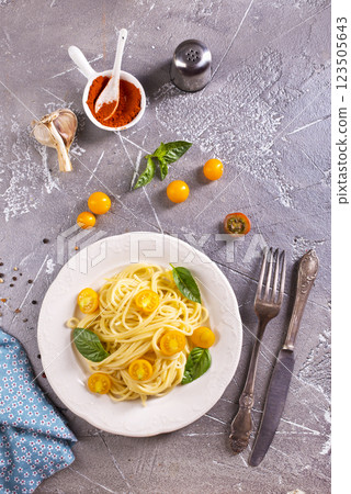 Pasta spaghetti with tomatoes and fresh basil in a plate Pasta spaghetti with tomatoes and fresh basil in a plate 123505643