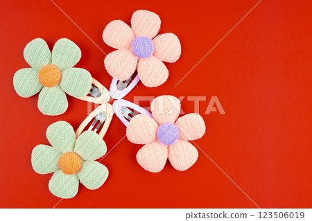 Flower hair clips on red background, Position with copy space. Flower hair clips on red background, Position with copy space. 123506019