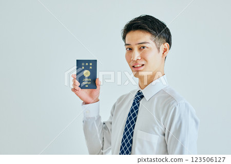 一名二十多歲的年輕人拿著護照 123506127