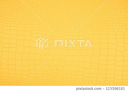 Yellow crocodile skin artificial leather with waves and folds on PVC base. Yellow crocodile skin artificial leather with waves and folds on PVC base. 123506181