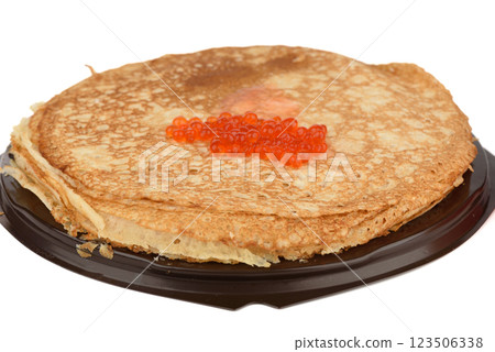 Pancakes with red caviar on a plastic tray over a white background. 123506338