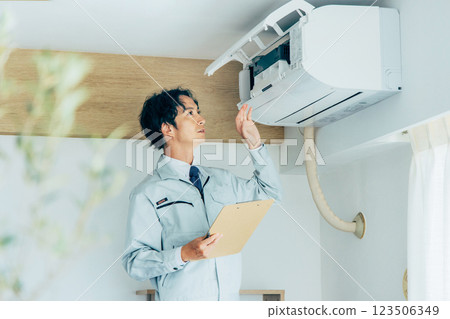 Workers inspecting air conditioners 123506349