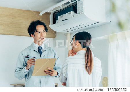 Workers inspecting air conditioners 123506352