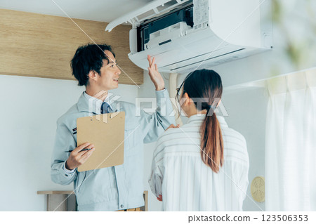 Workers inspecting air conditioners 123506353