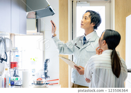 A worker inspecting a ventilation fan A worker inspecting a ventilation fan 123506364