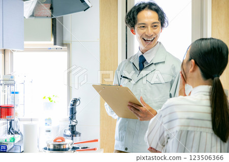 A worker inspecting a ventilation fan 123506366