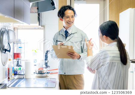 A worker inspecting a ventilation fan 123506369