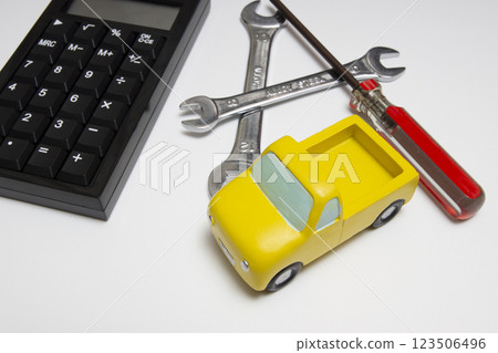 An image of repair costs with a truck miniature and tools 123506496