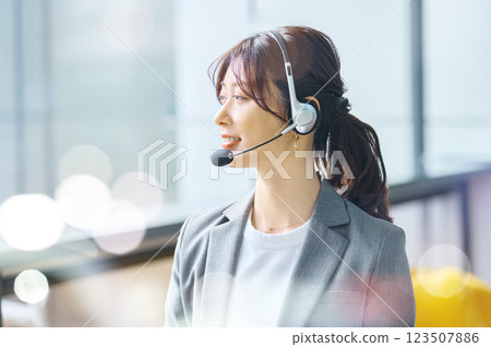 Female operator wearing an intercom Filming cooperation: SKY Perfect Tokyo Media Center Female operator wearing an intercom Filming cooperation: SKY Perfect Tokyo Media Center 123507886
