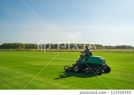 The Importance of Green Lawn Landscape Maintenance Utilizing a Riding Mower for Growth Efficiency and Density 123508349