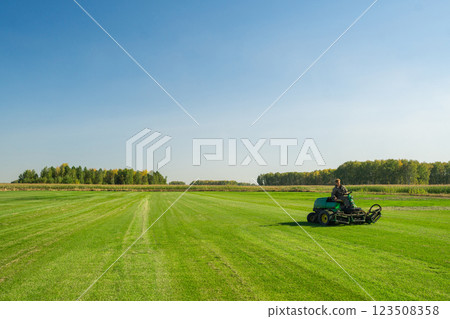 The Importance of Green Lawn Landscape Maintenance Utilizing a Riding Mower for Growth Efficiency and Density The Importance of Green Lawn Landscape Maintenance Utilizing a Riding Mower for Growth Efficiency and Density 123508358