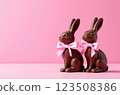 Chocolate rabbits symbol to Easter holidays on a pink banner background 123508386
