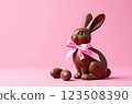 Chocolate rabbits symbol and eggs to Easter holidays on a pink banner background 123508390
