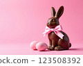 Chocolate rabbits symbol and eggs to Easter holidays on a pink banner background 123508392