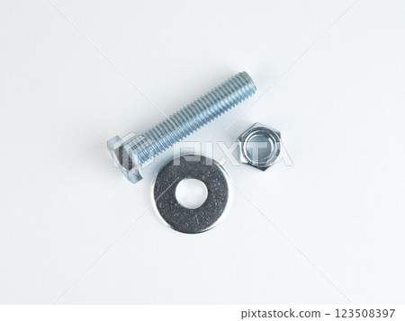 Bolts, washers, and nuts on surface Bolts, washers, and nuts on surface 123508397
