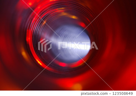 Bright red corrugated tunnel. View from inside the pipe. The curved, illuminated interior of the pipeline. 123508649
