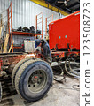 Yong man repar a truck in a shop 123508723