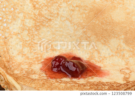Close-up of strawberry jam on freshly made pancakes. 123508799
