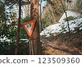 Slow down sign on a snowy hiking trail 123509360