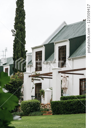 portion residential building classic architectural style white facade green roof 123509417