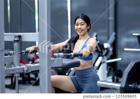 young woman exercising using tools in a sitting position young woman exercising using tools in a sitting position 123509605