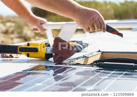 RV solar panel installation. Caravan roof repair 123509869