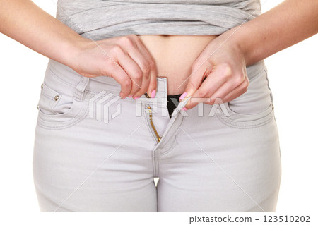 Woman with belly fat unable to close the pants Woman with belly fat unable to close the pants 123510202