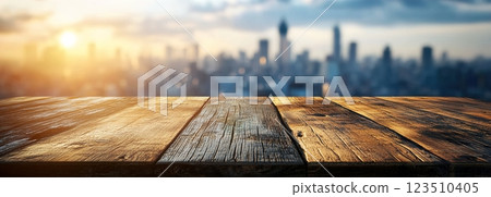 Wooden Table Surface with Sunset Blurry Cityscape and Nature Background, Warm Tones, and Soft Focus Lights Creating a Cozy Atmosphere for Relaxation Wooden Table Surface with Sunset Blurry Cityscape and Nature Background, Warm Tones, and Soft Focus Lights Creating a Cozy Atmosphere for Relaxation 123510405