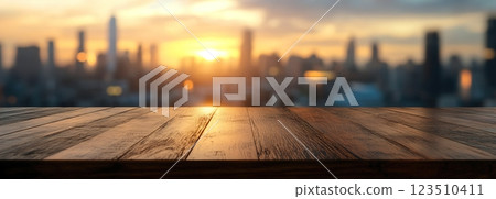 Wooden Table Surface with Sunset Blurry Cityscape and Nature Background, Warm Tones, and Soft Focus Lights Creating a Cozy Atmosphere for Relaxation 123510411
