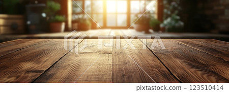 Wooden Table Surface with Sunset Blurry Cityscape and Nature Background, Warm Tones, and Soft Focus Lights Creating a Cozy Atmosphere for Relaxation 123510414