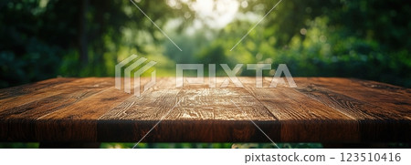 Wooden Table Surface with Sunset Blurry Cityscape and Nature Background, Warm Tones, and Soft Focus Lights Creating a Cozy Atmosphere for Relaxation 123510416