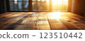 Wooden Table Surface with Sunset Blurry Cityscape and Nature Background, Warm Tones, and Soft Focus Lights Creating a Cozy Atmosphere for Relaxation 123510442